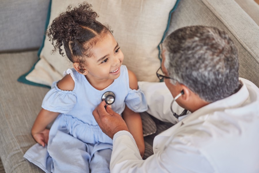 Young girl getting check up with physician 
